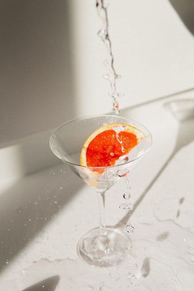Transparent glass, with orange liquid
